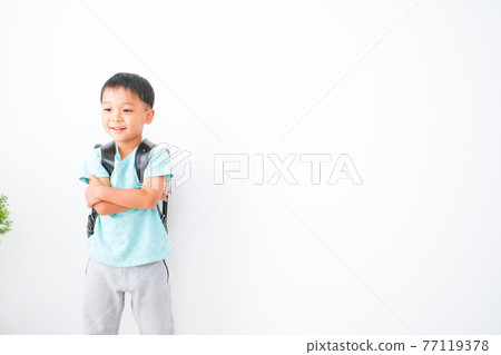 Boy carrying a school bag 77119378