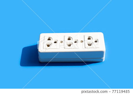 Electrical power strip on blue background. Top view Electrical power strip on blue background. Top view 77119485