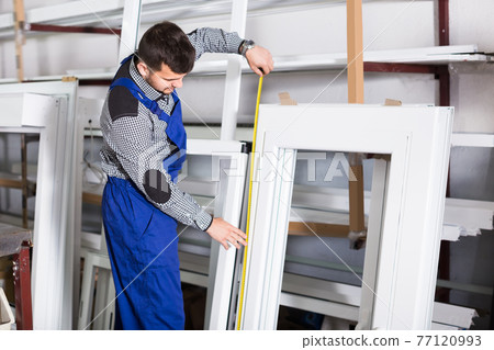 Young workman inspecting PVC manufacturing 77120993