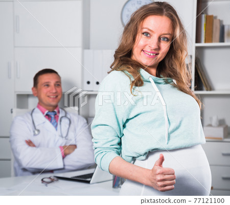 Doctor and pregnant visitor Doctor and pregnant visitor 77121100