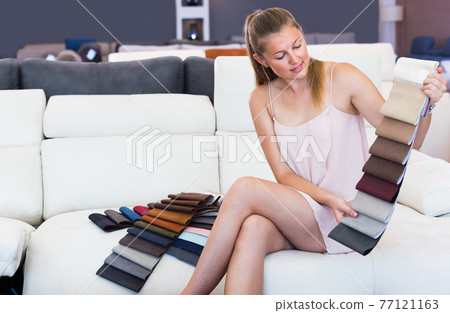Pretty woman touching color textile for sofa Pretty woman touching color textile for sofa 77121163