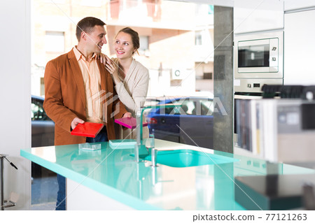 Happy spouses customers choosing tabletop Happy spouses customers choosing tabletop 77121263