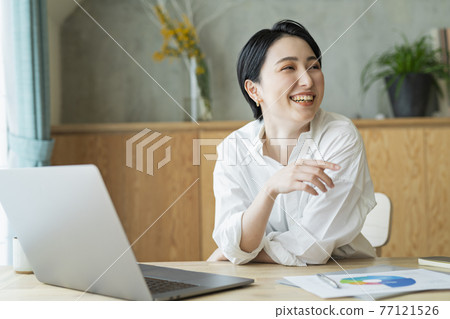 Woman working remotely 77121526