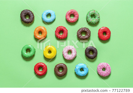 Donuts variety top view on a green background. Donuts variety top view on a green background. 77122789