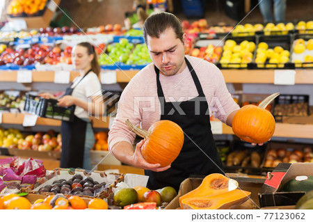 Adult man with pumpkin in hands Adult man with pumpkin in hands 77123062