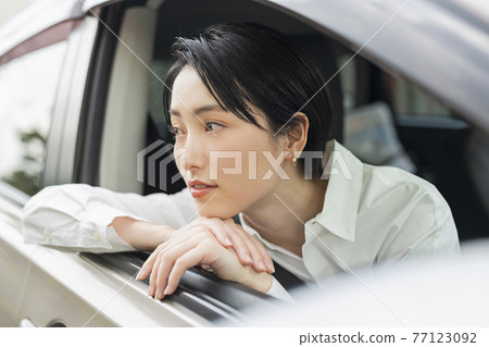 Woman looking out of the car 77123092