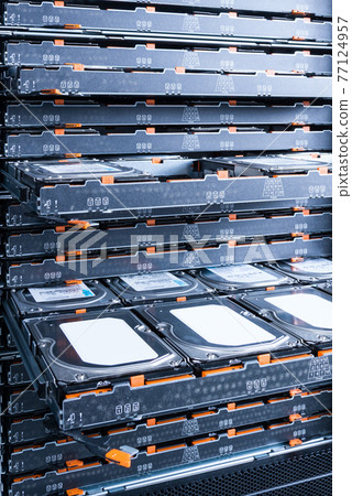 Cluster of hard drives inside open tray 77124957