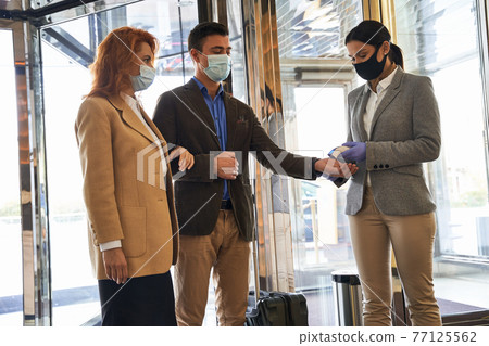 Sanitary rules require temperature measuring for the visitors Sanitary rules require temperature measuring for the visitors 77125562