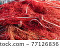 Red fishing nets with floats and ropes. Still-life shot, perfect image for fishing, aquaculture, intensive fishing and environmental protection. 77126836