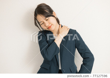 A woman in a suit who feels tired, stressed, and worried A woman in a suit who feels tired, stressed, and worried 77127596
