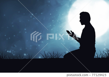 Silhouette of Muslim man sitting while raised hands and praying 77129423
