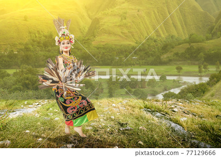 Asian woman dancing East Kalimantan traditional dance (Giring-Giring dance) Asian woman dancing East Kalimantan traditional dance (Giring-Giring dance) 77129666
