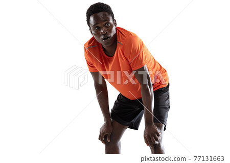 Close-up young African-American man, athlete isolated over white background. 77131663