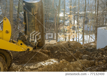 Heavy excavator excavating soil working during road works, moving soil during construction of the new road Heavy excavator excavating soil working during road works, moving soil during construction of the new road 77132400