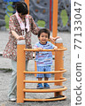 3-year-old boy playing with grandma in the park 77133047