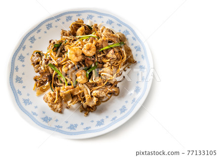 Overhead view of Penang char kuey teow is popular fried noodle with coceral, shrimp and eggs in black sauce in Malaysia Overhead view of Penang char kuey teow is popular fried noodle with coceral, shrimp and eggs in black sauce in Malaysia 77133105