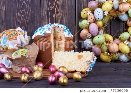 Sweet cupcake with cut slice on dark wooden background. Sweet cupcake with cut slice on dark wooden background. 77136096