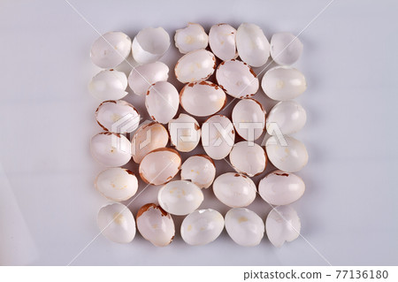 Top view hen shells on white surface. Top view hen shells on white surface. 77136180