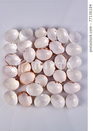 Square made of eggshells. Empty broken chicken eggs. Top Square made of eggshells. Empty broken chicken eggs. Top 77136184