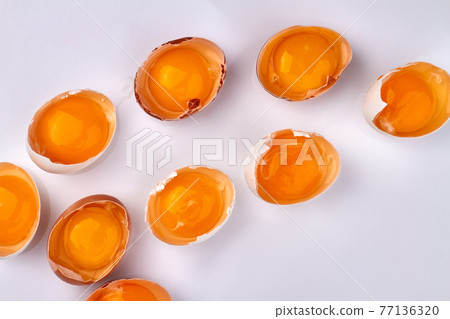 Broken chicken's eggs on white background. 77136320