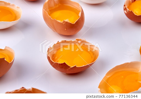 Close-up broken chicken eggs with yolk. 77136344