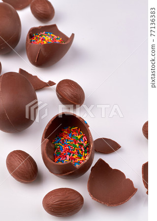 Sweet chocolate eggs with sprinkles. Sweet chocolate eggs with sprinkles. 77136383