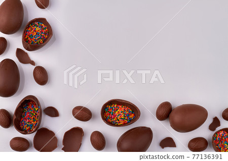 Chocolate eggs and copy space on white. Chocolate eggs and copy space on white. 77136391