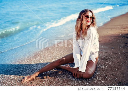 portrait of beautiful sexy Caucasian sunbathed woman in sunglasses portrait of beautiful sexy Caucasian sunbathed woman in sunglasses 77137544