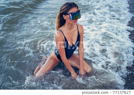 portrait of beautiful sexy caucasian sunbathed woman in sunglass 77137627