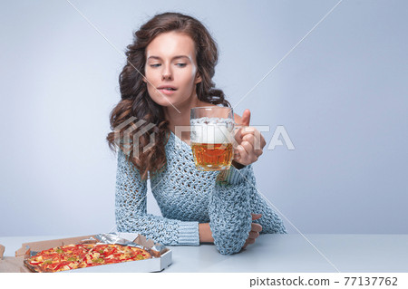 Happy woman with pizza and beer on grey background, space for text Happy woman with pizza and beer on grey background, space for text 77137762