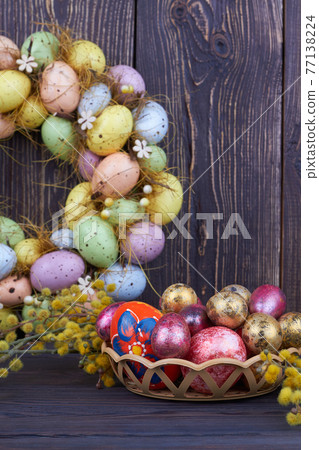 Colored easter eggs and yellow willow branch. Colored easter eggs and yellow willow branch. 77138224