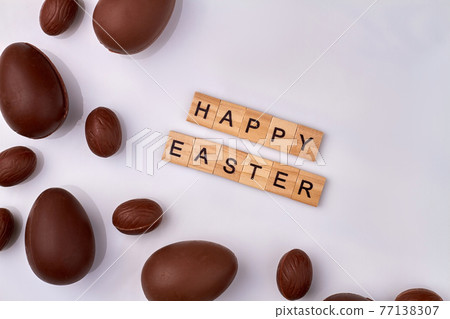 Happy easter wish and chocolate eggs. Happy easter wish and chocolate eggs. 77138307
