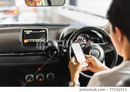 Irresponsible man using smart phone while driving. 77142015