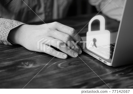 A man works at a laptop. Computer security concept. A man works at a laptop. Computer security concept. 77142087