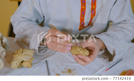 Potter making clay figure for board game Potter making clay figure for board game 77142419