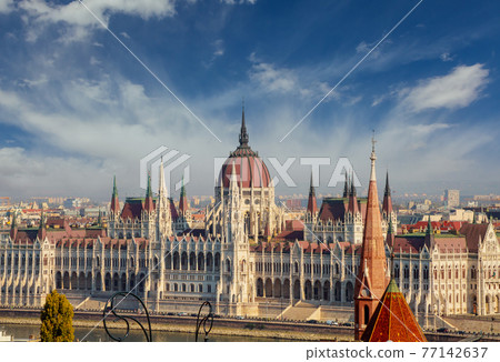 View of the tower Hungarian parliament rooftops of the historic Old Town of Budapest Hungary from a height. 77142637