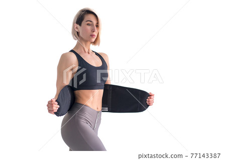 Girl doing fitness back belt slimming isolated on white backgrou 77143387