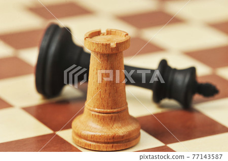wooden chess pieces on a chessboard wooden chess pieces on a chessboard 77143587