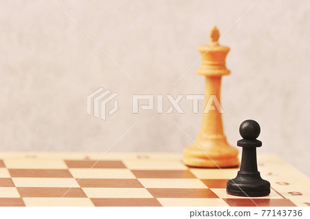 chess on a chessboard - white pawn in front of the black king chess on a chessboard - white pawn in front of the black king 77143736
