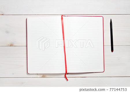 Red notebook on a white wooden background Red notebook on a white wooden background 77144753