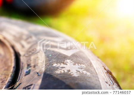 Winter tires close up. Self replacement of winter tires on a car with summer wheels. Swap winter wheel for summer tire. Winter tires close up. Self replacement of winter tires on a car with summer wheels. Swap winter wheel for summer tire. 77146037