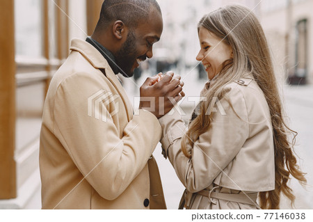 Mixed couple spenting time together in a spring city 77146038