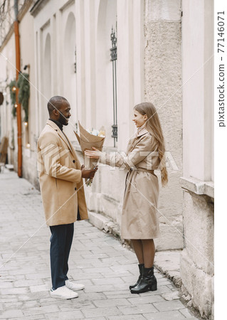 Mixed couple spenting time together in a spring city 77146071