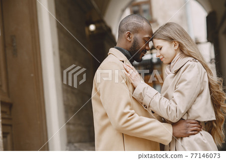 Mixed couple spenting time together in a spring city Mixed couple spenting time together in a spring city 77146073