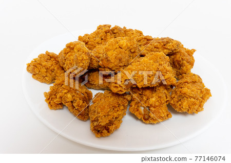 Deep fried spicy chicken wings in a crispy breadingon plate, chicken fast food isolated on white background Deep fried spicy chicken wings in a crispy breadingon plate, chicken fast food isolated on white background 77146074