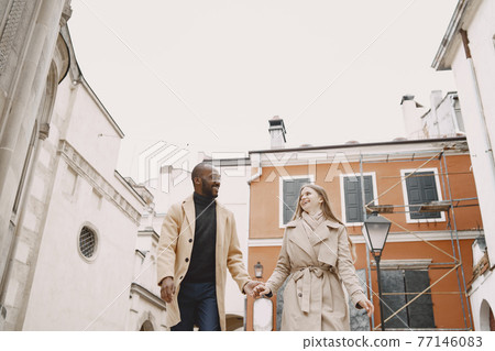 Mixed couple spenting time together in a spring city 77146083