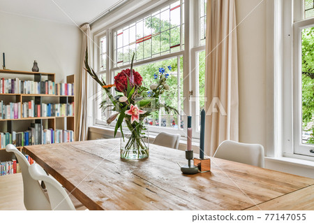 Flowers and candles on dining table Flowers and candles on dining table 77147055