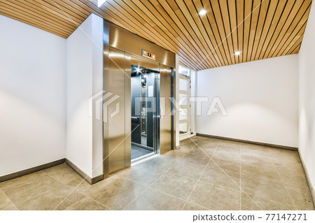 Modern elevator in apartment building hall 77147271