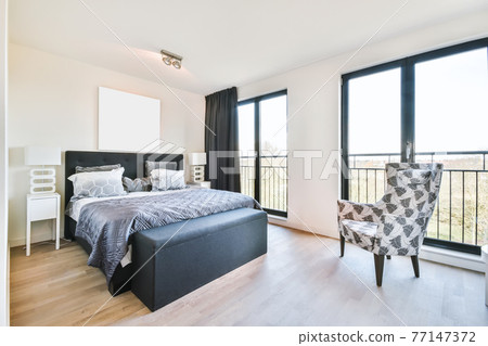 Spacious modern bedroom with panoramic windows Spacious modern bedroom with panoramic windows 77147372
