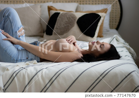 Sensual woman touching naked breast in bedroom Sensual woman touching naked breast in bedroom 77147670